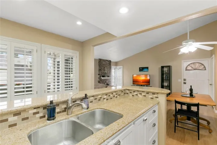 Dual paned windows with plantation shutters throughout provide plenty of natural light.  Dual stainless steel sink and light granite counters and glass backsplash are a neutral backdrop for you to personalize.