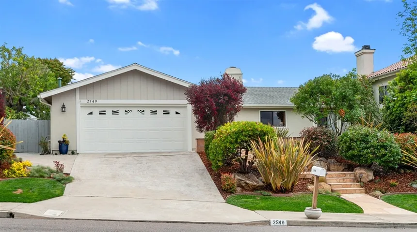 Double car garage with spacious area for workspace and custom built in cabinets