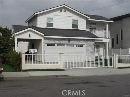 Front view: gated, carport, two car garage and plenty of on site parking spaces.