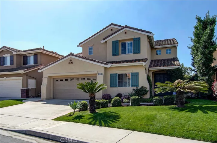 Stately street appeal with sweaping lawn, stone walkway, covered front porch and classic California Monterey Style details.