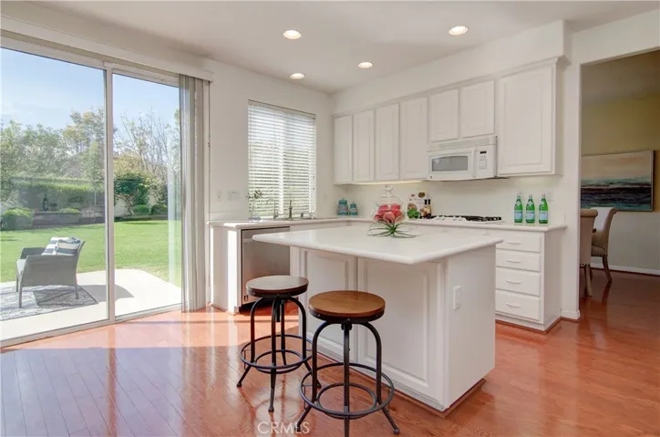 This is every chef's dream kitchen...so much bright white cabinetry and prep space...and who doesn't love a sink with a view?!