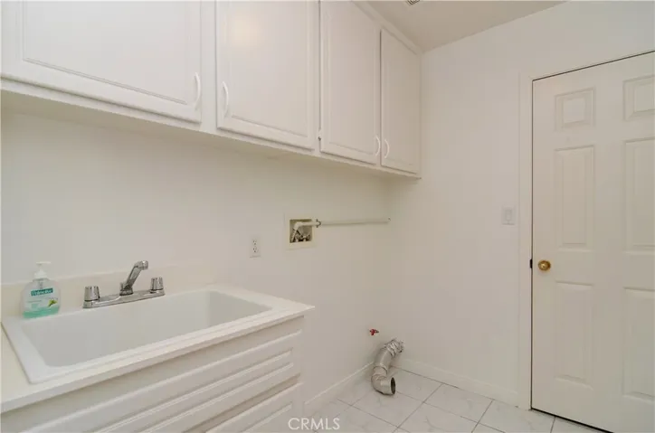 Convenient inside laundry room has lots of cabinetry and...the ultimate COSTCO room...complete with shelving!