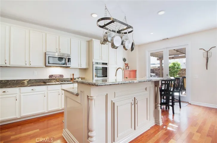 Custom wood crafted center island with sink and slab granite.