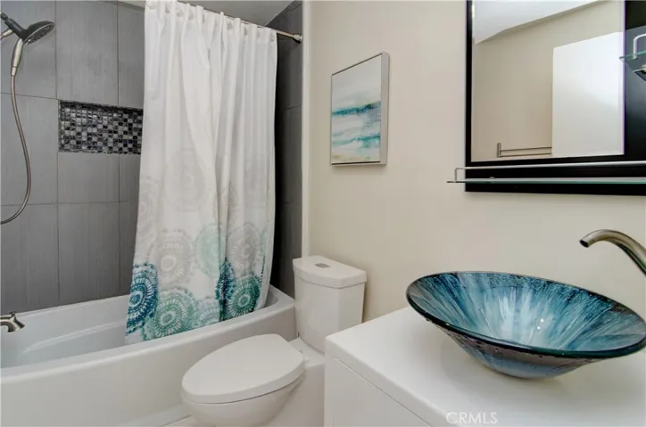 Gorgeous second bath has deep soaking tub and designer accents.