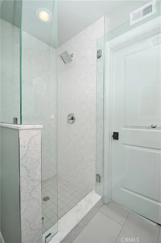 Master bathroom walk in shower with glass enclosure.