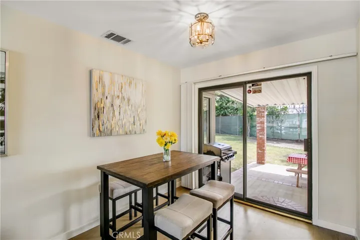 The dining area flows seamlessly to the back patio for extended gatherings!