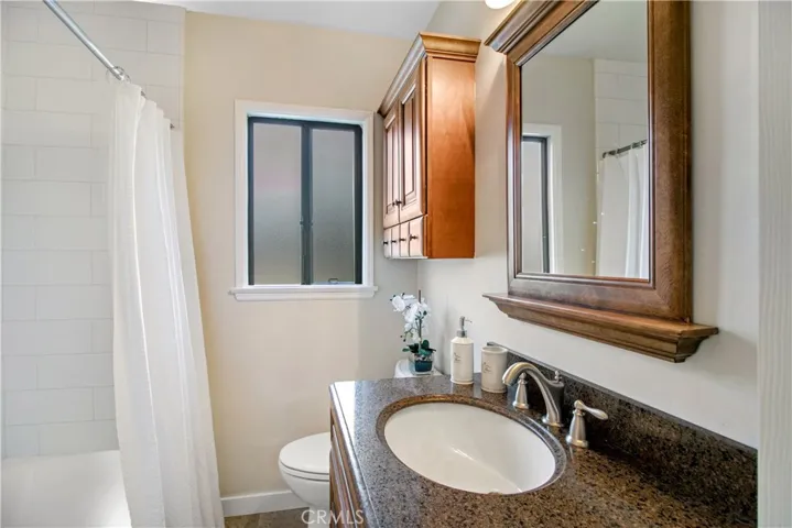 Yep, that is brand new tile in the tub area plus new vanity, medicine cabinet, mirror and commode...new porcelin tile flooring too!