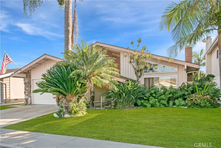 Welcome home. Best exterior elevation has a nod to Mid Century architecture with sweeping porch roof, vertical board and batten siding and Palos Verde stone (behind Palm).
