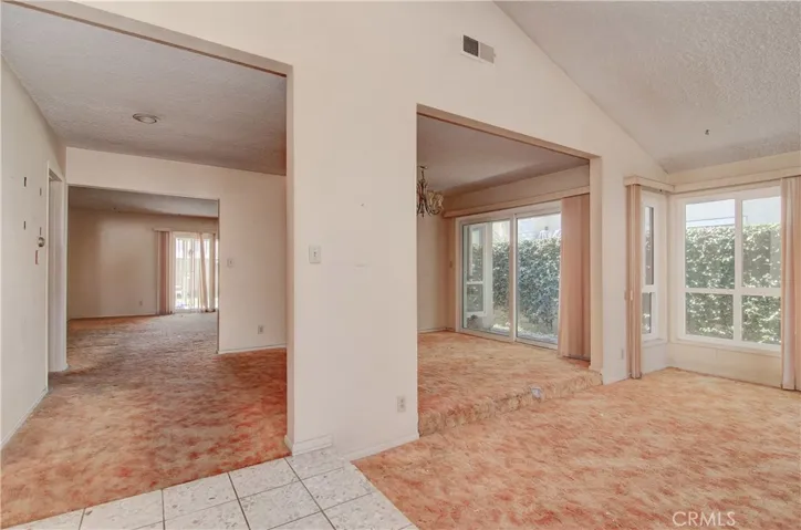 Entry with original mid century 'Terrazzo Tile' flooring looking ahead to Formal Dining & Family Room beyond.
Step down Living Room to right.