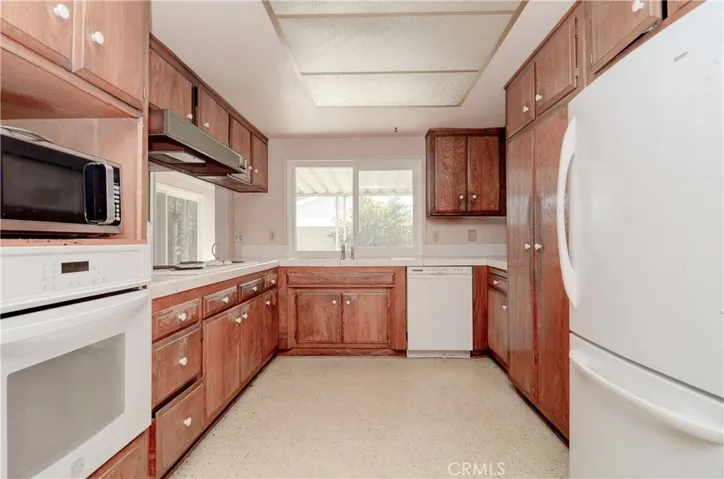 Long view of Kitchen towards rear yard and covered patio.