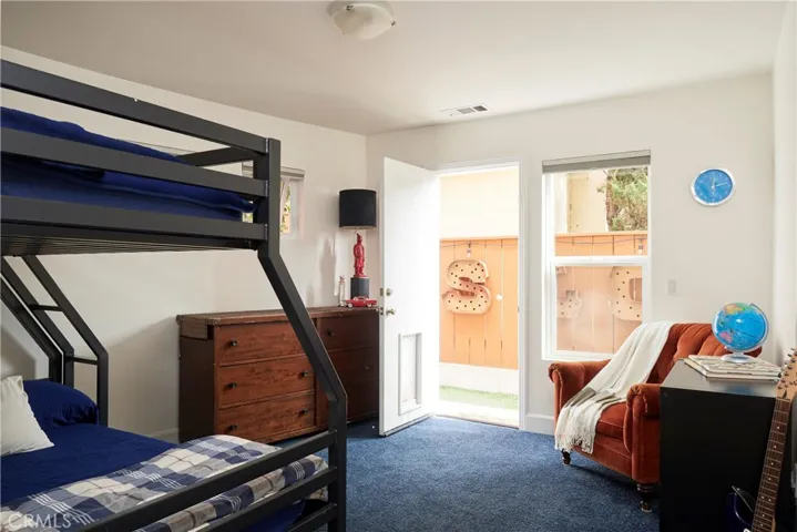Lower floor second bedroom with door to the back yard