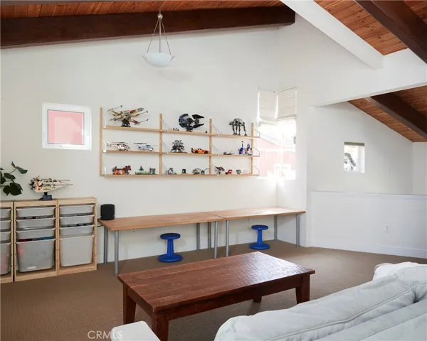 Vaulted master bedroom suite with generous amounts of windows and light entering.