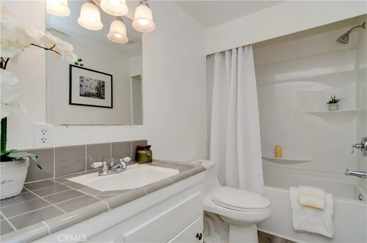 Sparkling hall bath has updated tub/shower and fixtures...love this retro feel!