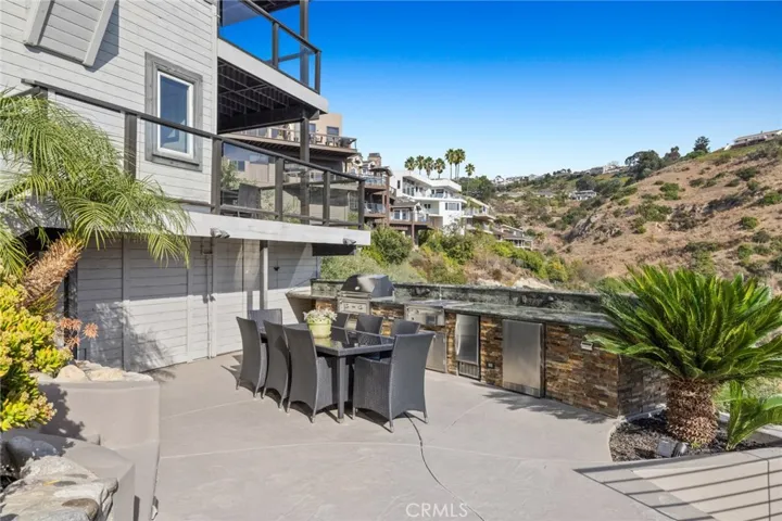 Built-in BBQ and outdoor kitchen, a fire pit, and room for a future pool.
