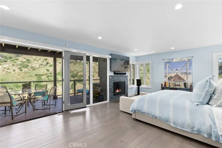 The sumptuous fireplace-warmed master suite boasts a private view deck, sauna, soaking tub and oversized shower.
