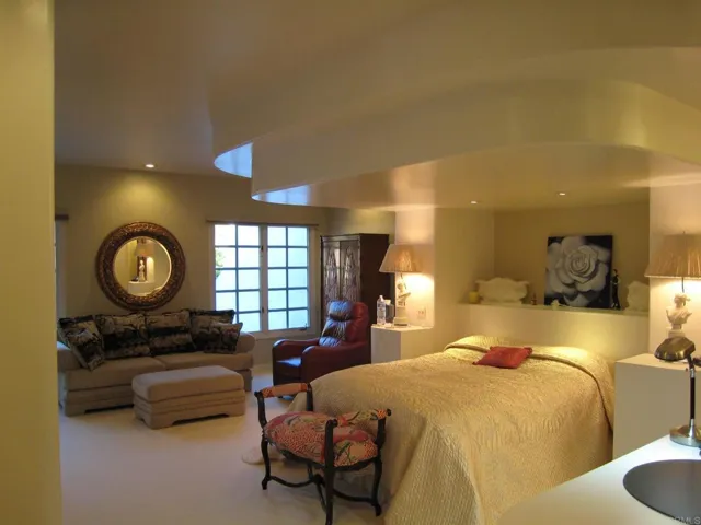 The large master bedroom has many custom built in features and a wall to wall walk-in closet.
