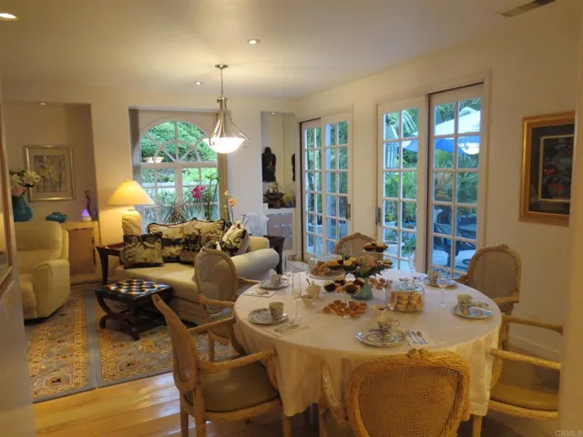 The dining/family room offers many custom built-ins, windows and sliders to large private patio.