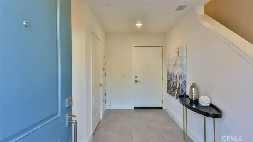 Welcome home. Entry foyer at front door / garage entrance / dumb waiter.