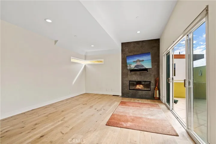 Gas fireplace oriented as a focal point along with the balcony