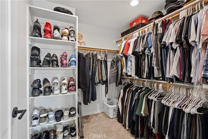 Primary bedroom walk-in closet