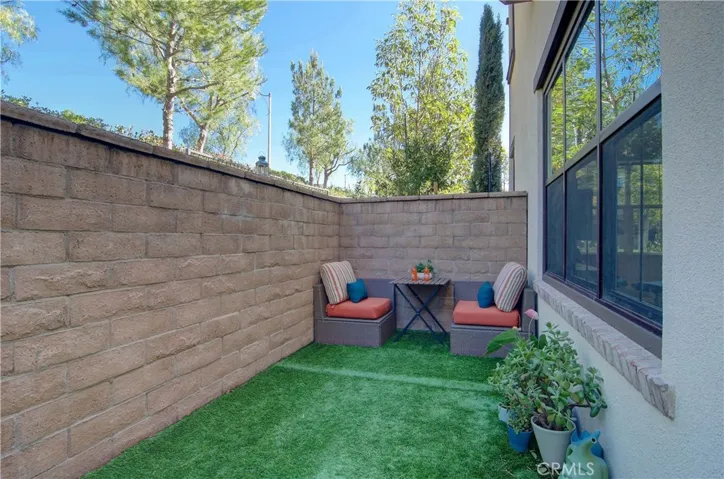 Easy to manage yard with artificial grass/brick underneath.