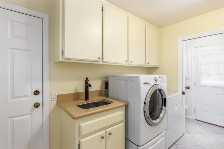 Generous laundry with half bath & access to back patio & spa.