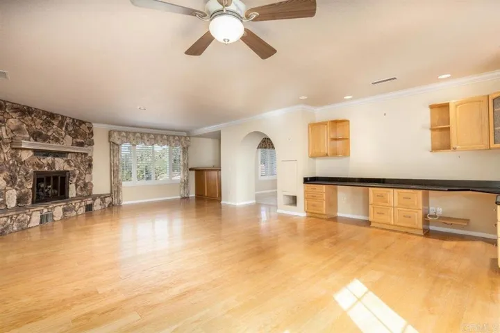 Great fireplace off of breakfast area with built-in desk space & off of kitchen.
