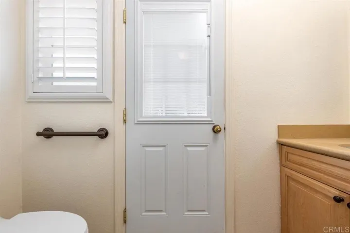 Half bath off of laundry room with door out to back patio and spa.
