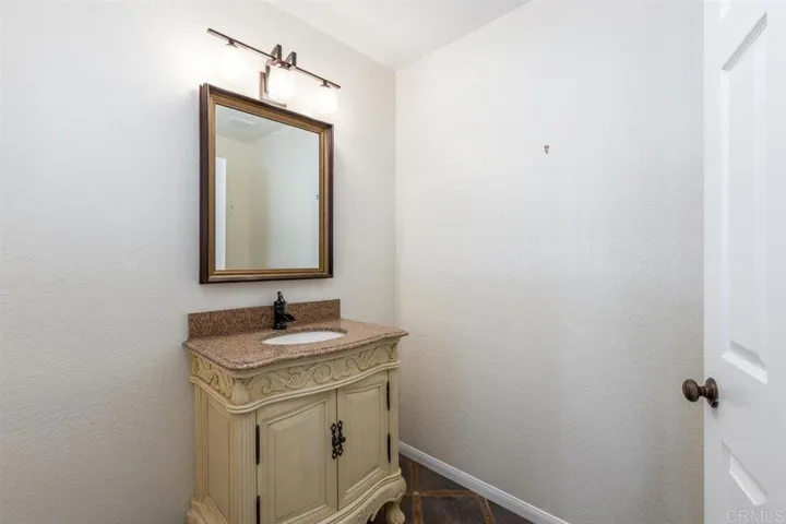Powder room off entry.