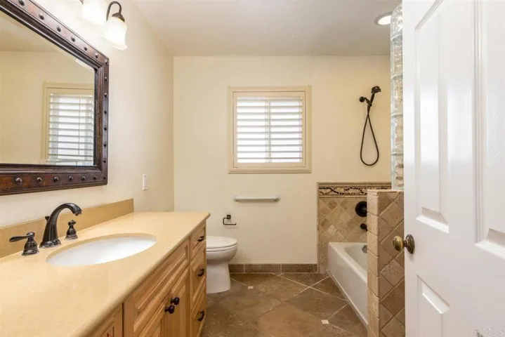 Hall bathroom w/custom tilework.