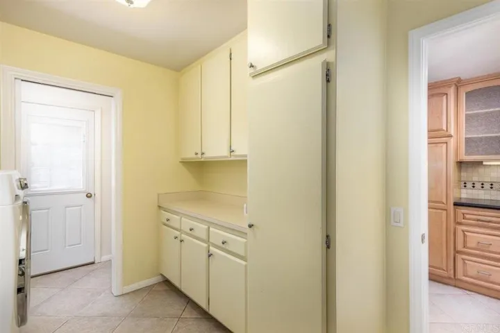 Opposite view of laundry room with tons of storage! Just off of kitchen and attached garage entry.
