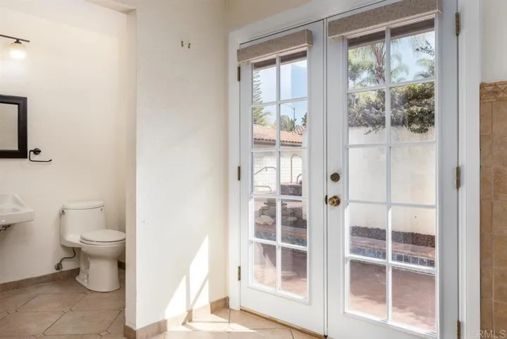 French doors off master bath to back patio & spa. Notice the 'wheelchair accessible' sink.