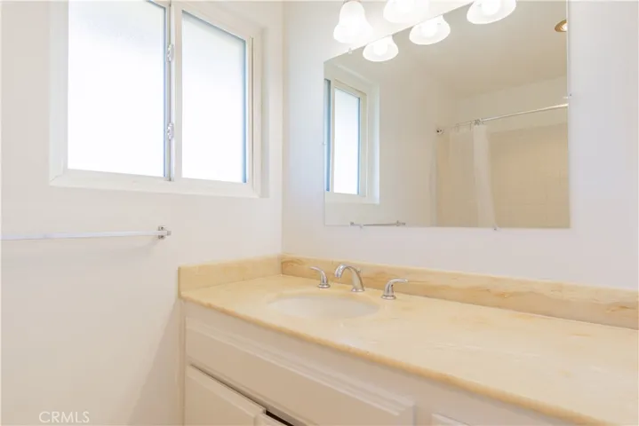 Upstairs bathroom with new fixtures, lighting, and mirrors