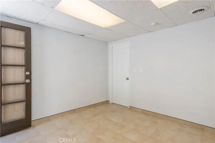 This is the downstairs bonus room adjacent to garage. It is not included in the 1296 sq ft of the unit.