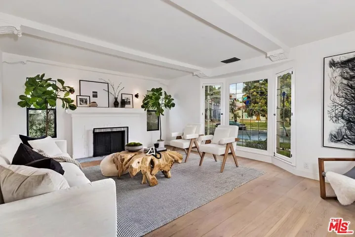 Isolated formal living room wi original beams and moldings
