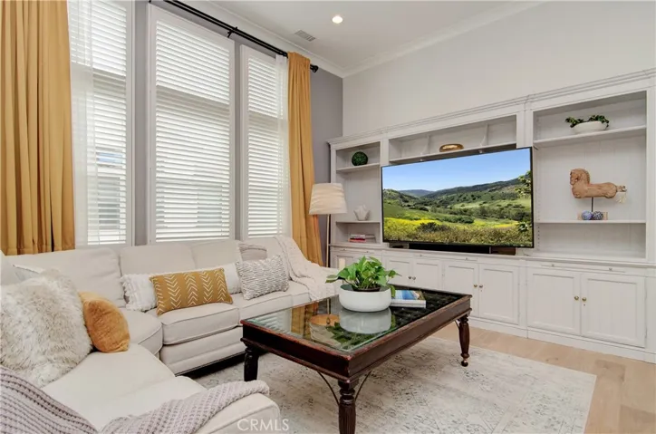 Sophisticated yet so cozy.  This living room is nice and bright with nearly floor to ceiling windows.