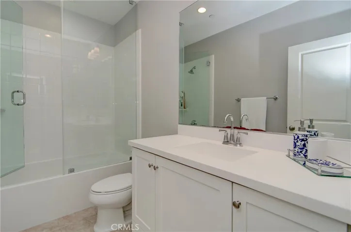 Gorgeous secondary bathroom with added glass shower doors.