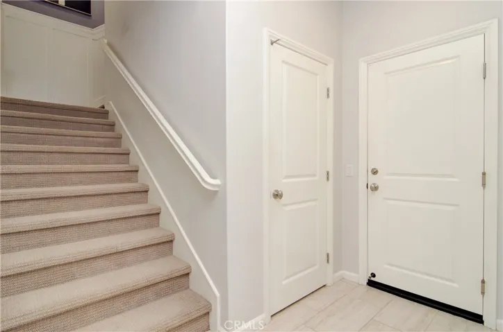 Come on up, or head into the garage. Notice the upgraded stair paneling.