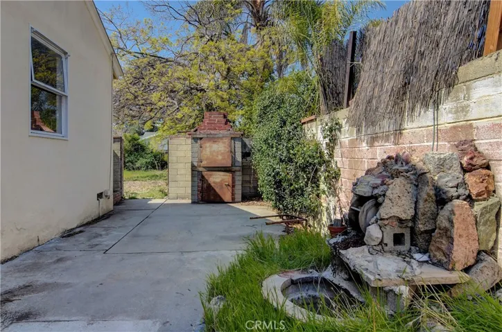Huge side patio right outside the kitchen door. Perhaps the old incinerator can become the new BBQ and cooking center? Note the side yards here are super wide, meaning lots of 'social' distance between you and the neighbor ;-)