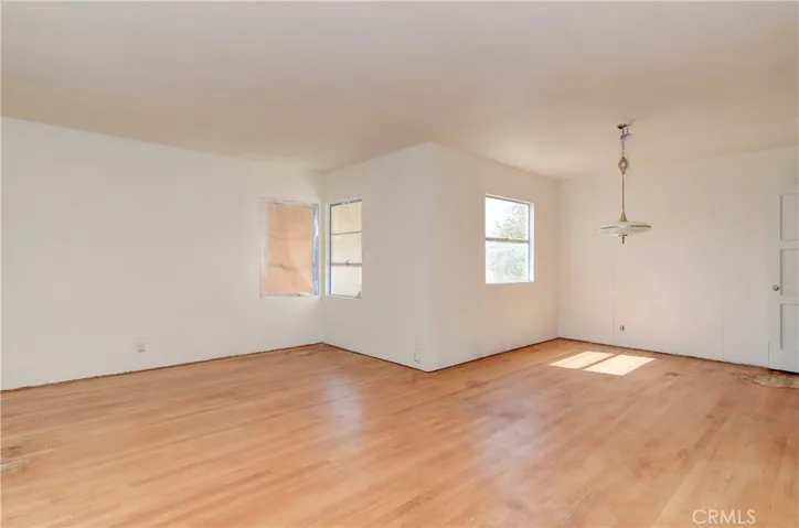 Natural light floods the Living and Living area, note the original hardwood floors!