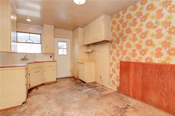 Original Kitchen ready for the hammer and your new inspirations put into play! Note wood wainscoting is separate nook area....oh the potential!