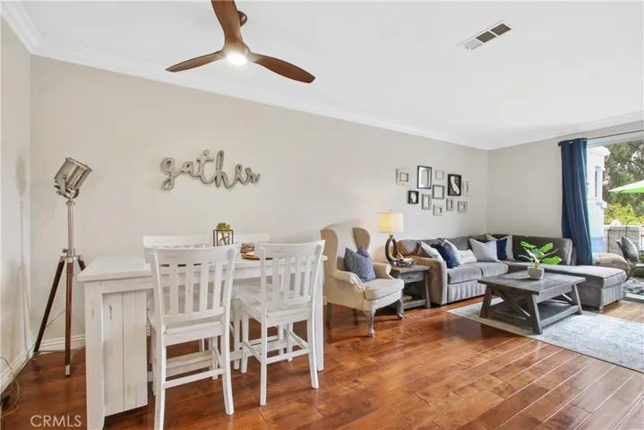 Elegant modern fan with lighting above the dining area.