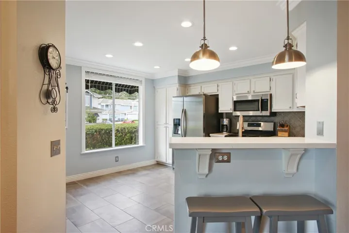 It's all about the details! Feast your eyes on the wood details under the countertop and Modern Farmhouse style stainless light fixtures. Plenty of natural light from the oversized window plus an abundance of recessed LED lighting!