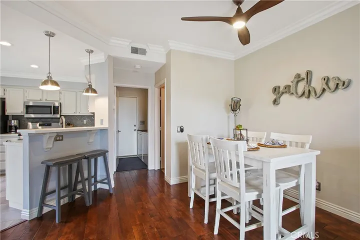 Casual eating and conversation with the cook while sitting at the breakfast bar! In the background you can see the door to the powder room and the garage door in the laundry room.