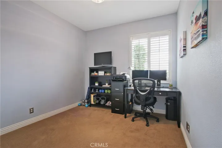 The third bedroom also features plantation shutters & custom wall paint. Notice the stainless steel electrical outlet covers - this high level of detail can be seen throughout this beautiful home!