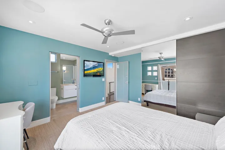 Another view of the upstairs bedroom, with mirrored closet door.