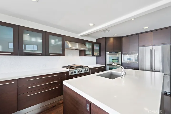 No expense was spared with these contemporary custom cabinets, quartz counters and deluxe appliances!  Note the abundant storage in upper cabinets and lower drawers.