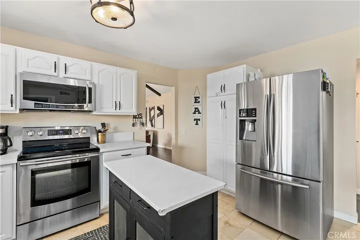 Roomy kitchen with new quartz counter tops, movable island