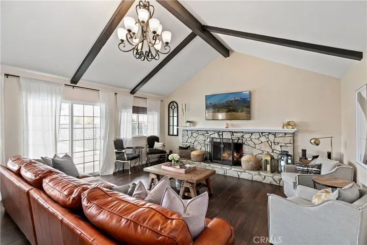 Large family room perfect for family gatherings.  Beamed ceilings, wood burning fireplace, views of the pool