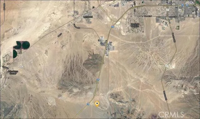 Zoomed out photo showing Barstow in the top right. Outlet center is in the center of the photo.  Subject property is at the bottom of the photo, marked with a white/yellow balloon.